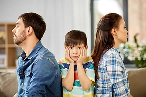 family problem, divorce and people concept - unhappy father, mother and sad little son at home